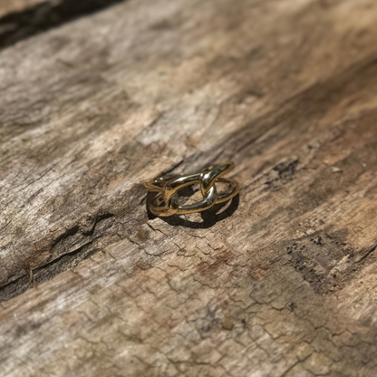 Anel dourado com design de elos em detalhe frontal